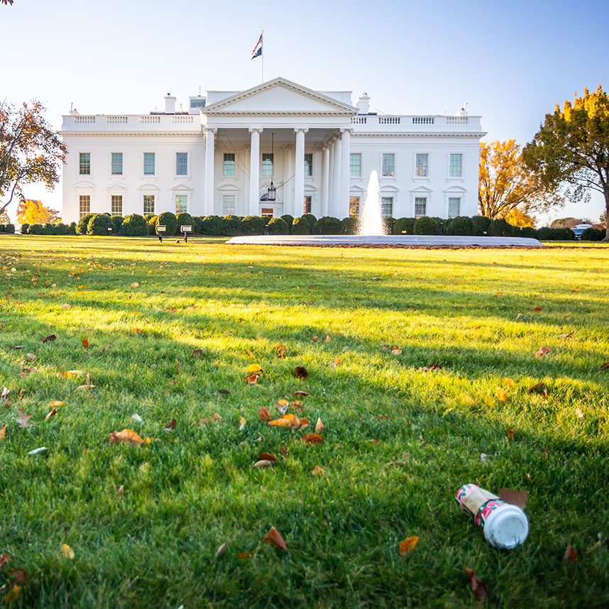 The White House lawn with a discarded cup on the grass.