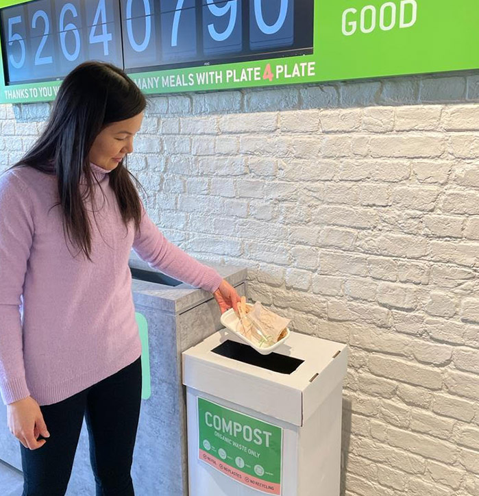Zambrero UK CEO Emily Teh putting BioPak compostable packaging in their compost bin