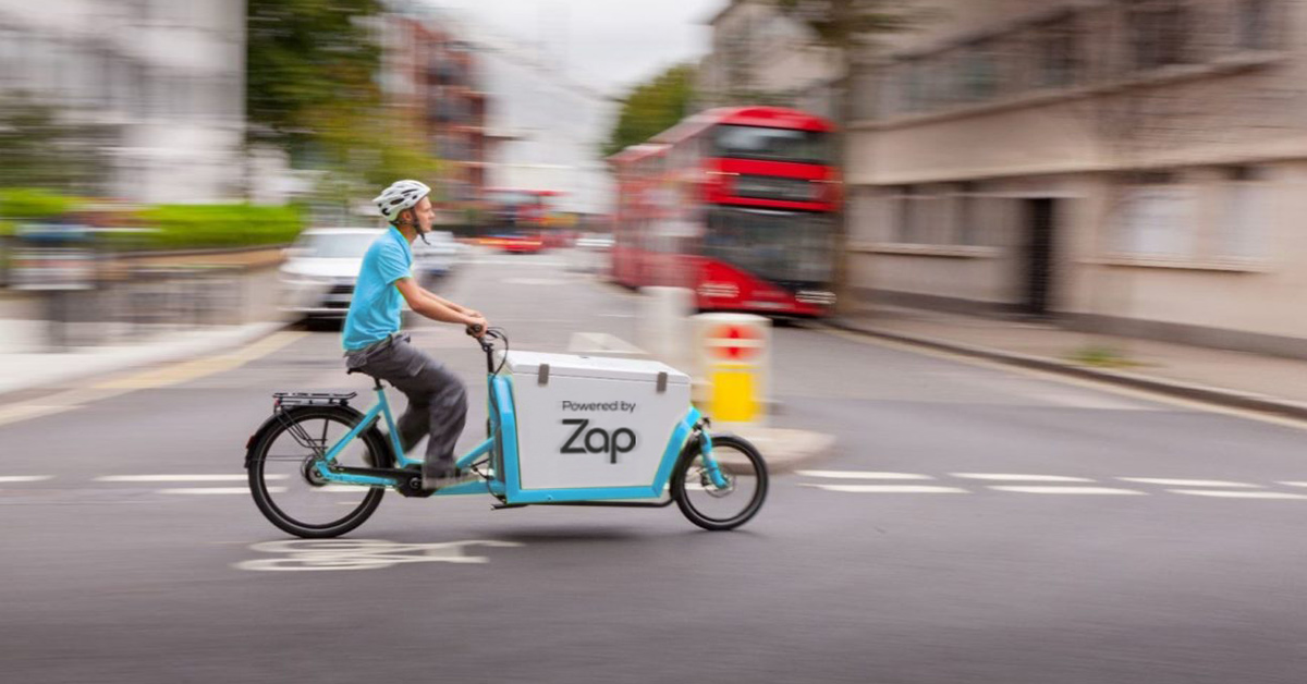 Zap Waste employee riding electric bike through London