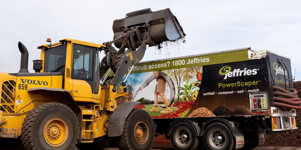 Heavy machinery shovelling soil into a truck